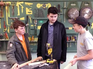 students discuss a shop class project